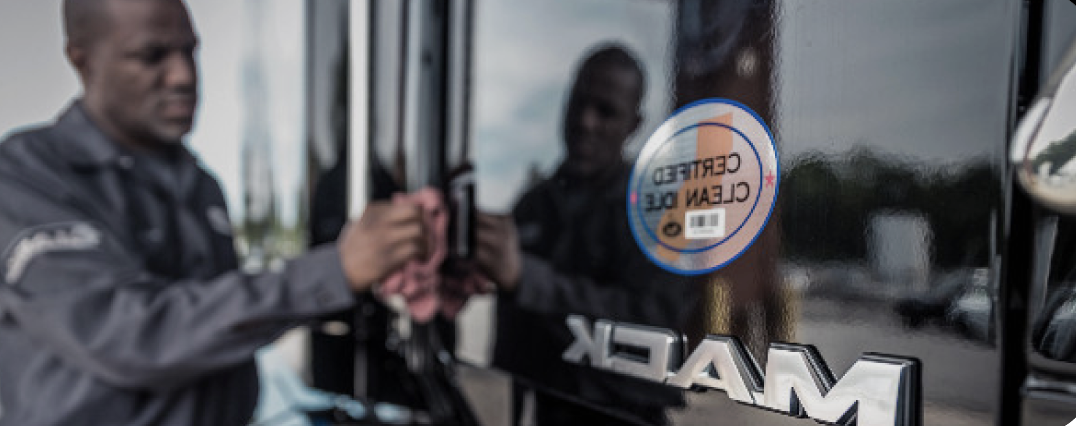 Technician cleaning a Mack truck